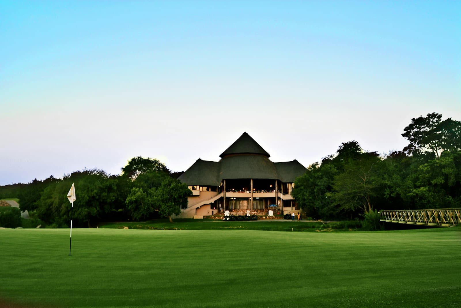Country club grounds and clubhouse beyond the course